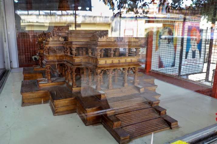 India Tv - A wooden model of the 'proposed Ram Temple' in a glass encasement, at the Ram Janmabhomi Nyas-run workshop at Karsevakpuram in Ayodhya. (Photo/PTI)