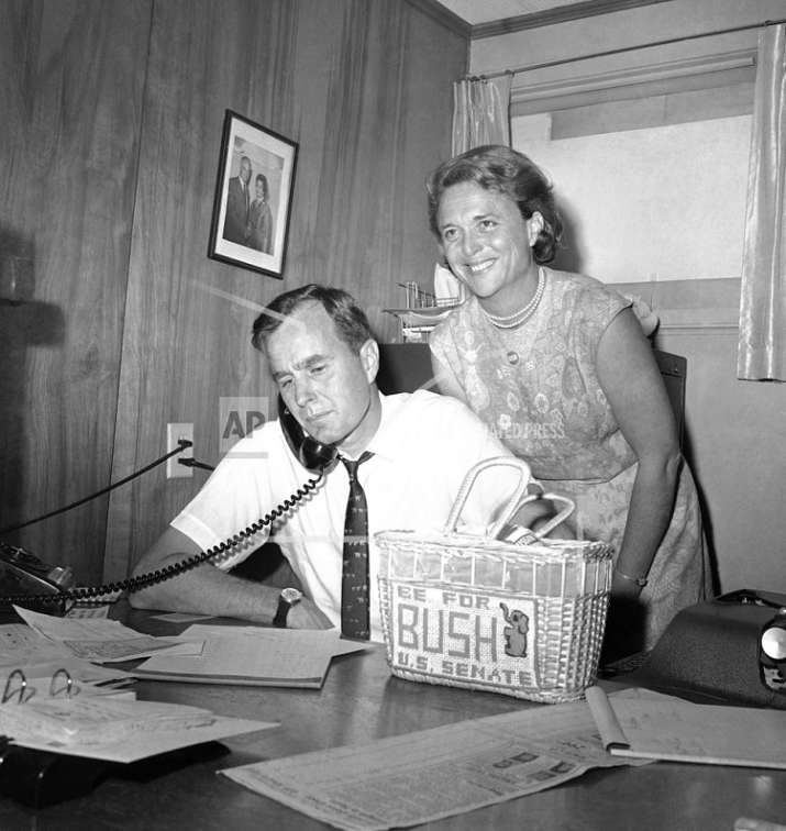 India Tv - In this June 6, 1964, file photo George HW Bush, candidate for the Republican nomination for the US Senate, gets returns by phone at his headquarters in Houston, as his wife Barbara, smiles at the news. (AP Photo/Ed Kolenovsky, File)  
