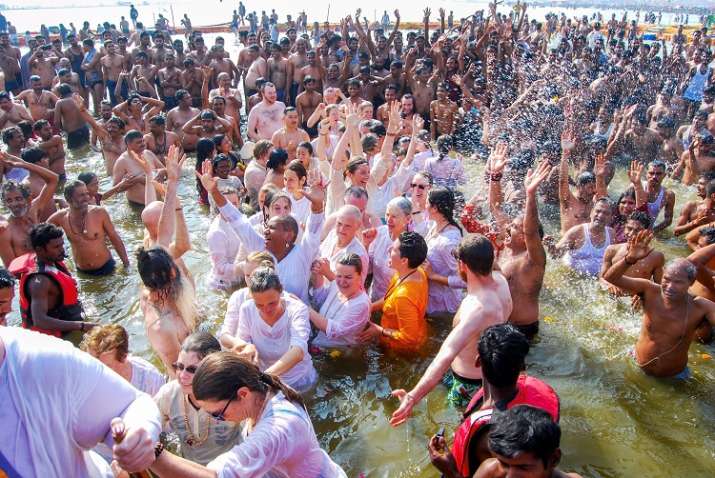 India Tv - Foreign devotees take a holy dip at Sangam on the occasion of 'Paush Purnima' during Kumbh Mela