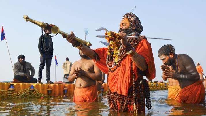 India Tv - A Sadhu holds a trident as he takes a holy dip at Sangam on the occasion of 'Paush Purnima' during Kumbh Mela