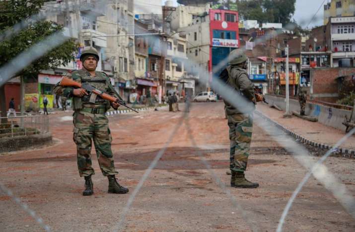 Army personnel stand guard at Gujjar Nagar area during a