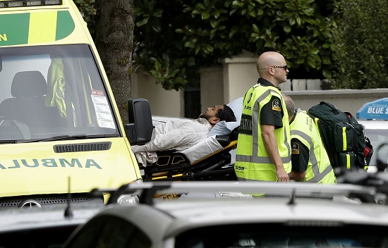 Ambulance staff take a man from outside a mosque in central