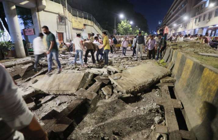 India Tv -  
Mumbai: A general view shows a part of the partially collapsed foot overbridge near a train station in south Mumbai,