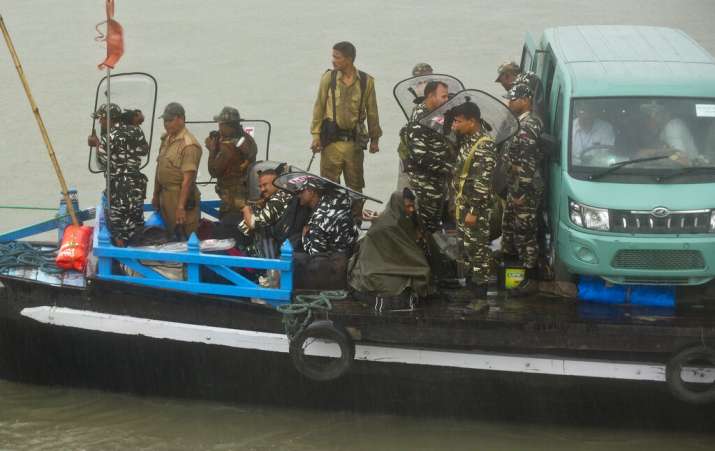 India Tv - Election officials and paramilitary soldiers travel with election material on a ferry through the river Brahmaputra ahead of first phase of elections in Nimati Ghat in Jorhat, Assam, India, Tuesday, April 9, 2019. India's general elections will be held in seven phases starting April 11. 