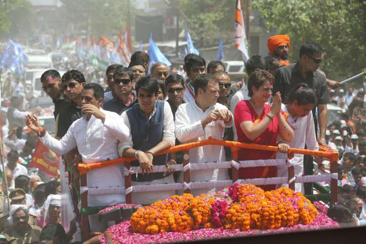India Tv - Congress party chief Rahul Gandhi, center in white, accompanied by his sister Priyanka Vadra in red arrives to file his nomination papers for the upcoming general elections in Amethi, Uttar Pradesh state, India, Wednesday, April 10, 2019. Gandhi, the scion of India's most famous political dynasty, filed nomination papers in the family stronghold of Amethi hoping to hold onto a key seat for a fourth consecutive time in national elections that begin Thursday. 