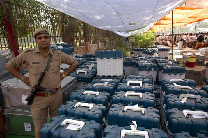 India Tv - A policeman stands guard next to voter-verified paper audit trail or VVPAT machines at a distribution center for the first phaseof general elections, in Ghaziabad, outskirts of New Delhi, India, Wednesday, April 10, 2019.