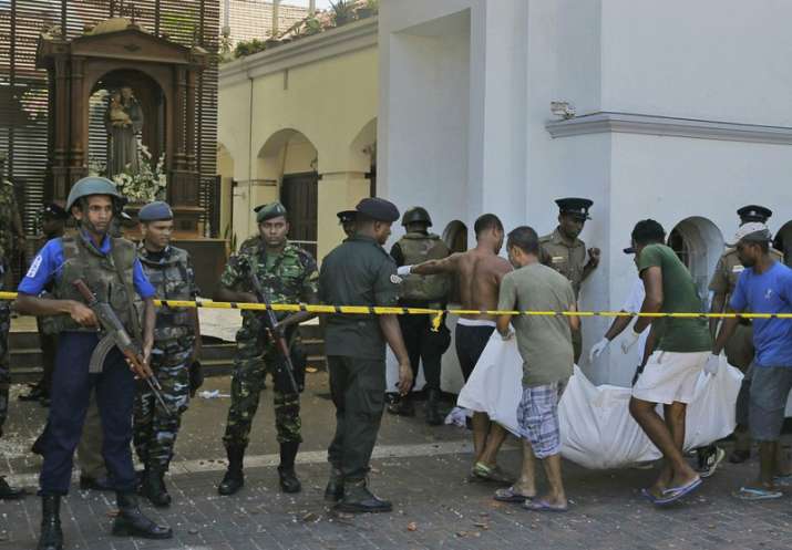 In this Sunday, April 21, 2019, photo, Sri Lankans carry a