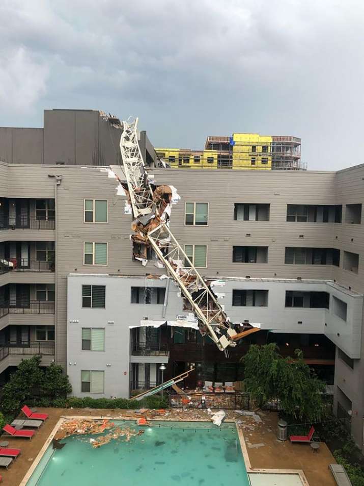India Tv - Construction crane falls on building during storm