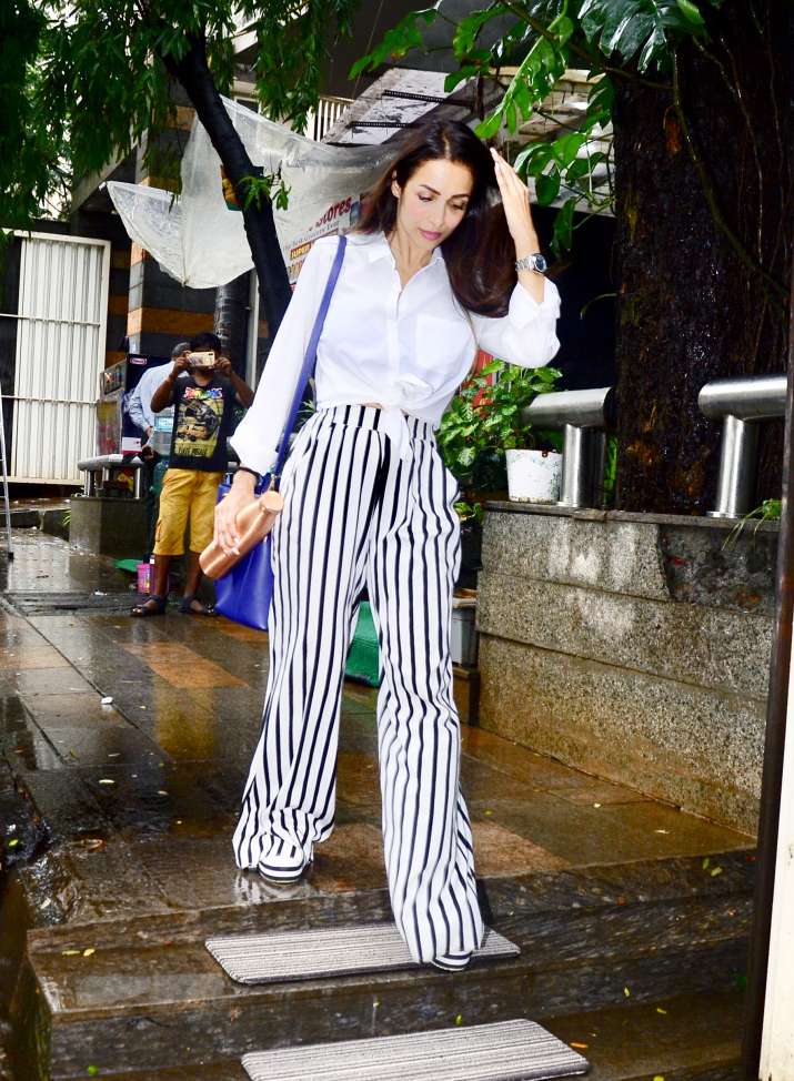 Malaika Arora's fashion game seems on point as she was spotted in white  shirt and striped pants | Fashion News – India TV