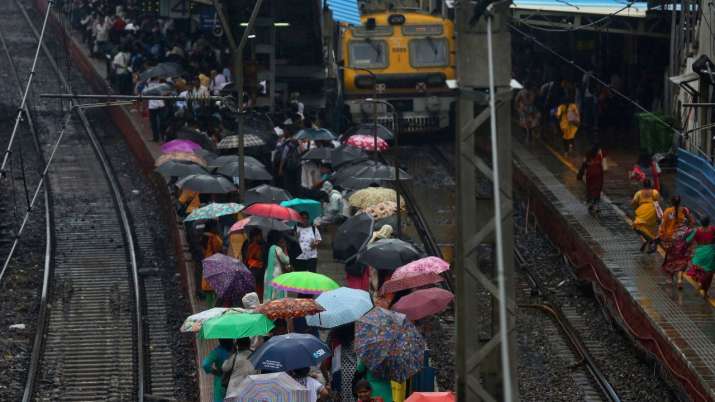India Tv - Trains were delayed, which led to many people queuing up at various railway stations to reach their destinations.  Railway tracks between Sion railway station and Matunga railway station were submerged following heavy rainfall in parts of Maharashtra.  