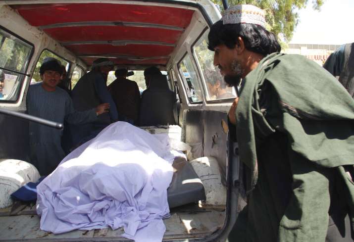 Afghans transport the body of a woman who was killed during