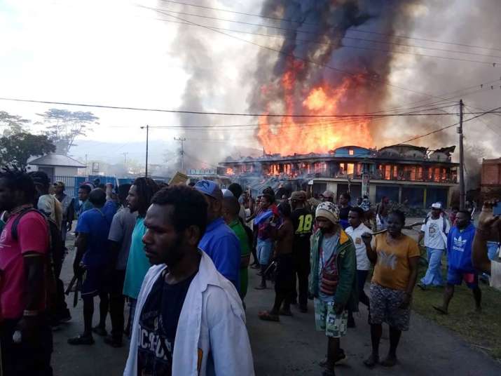 An angry mob torched local government buildings, shops and