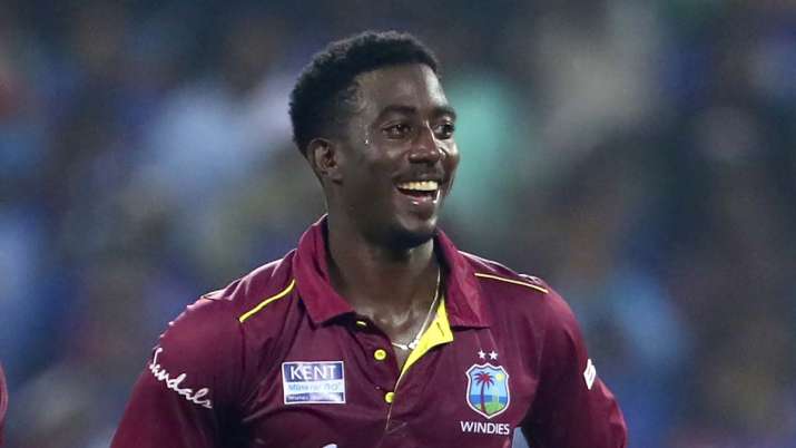 West Indies' Hayden Walsh celebrates the dismissal of
