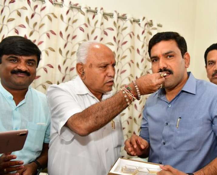 Yediyurappa celebrates with son as BJP set for majority in