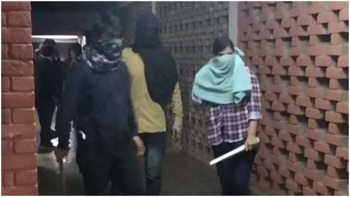 The masked people carrying sticks, accused of assaulting
