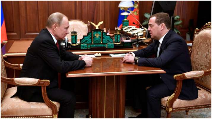 Russian President Vladimir Putin, left, listens to Russian