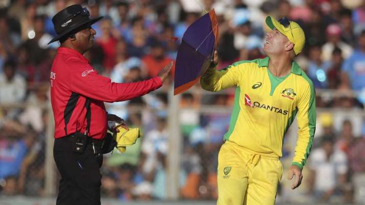 Australia's David Warner, right, holds a kite that fell on