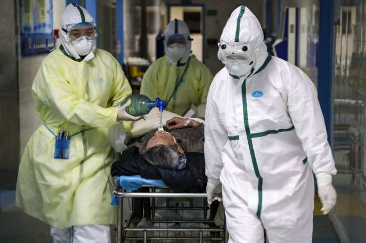 India Tv - In this Thursday, Feb. 6, 2020, photo, medical workers transfer a patient in the isolation ward for 