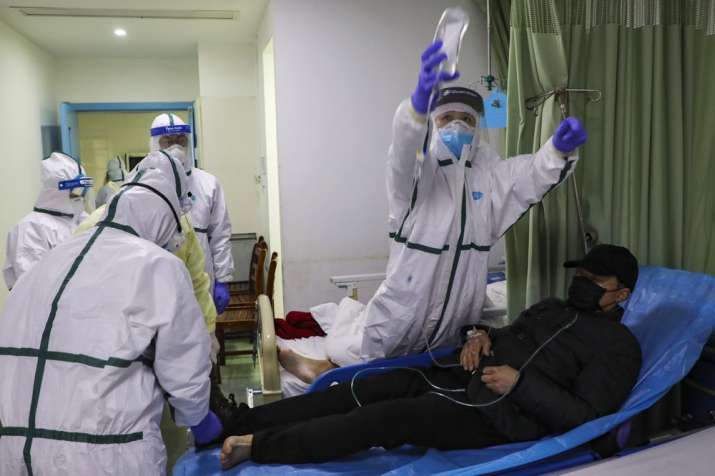 India Tv - In this Thursday, Feb. 6, 2020, photo, medical workers move a man into the isolation ward for 2019-n