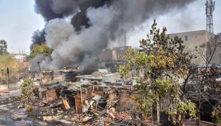 Smoke billows from Gokalpuri neighbourhood during clashes between those against and supporting the C