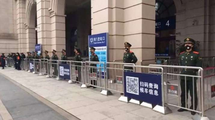 Chinese paramilitary police stand guard outside the closed