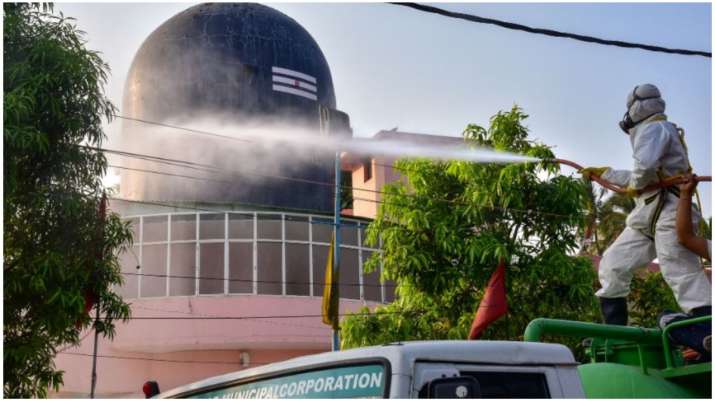 A GHMC worker sprays disinfectant to mitigate the coronavirus pandemic, during a nationawide lockdow