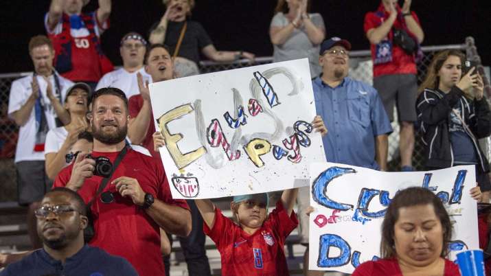 A young United States fan holds up a sign advocating for
