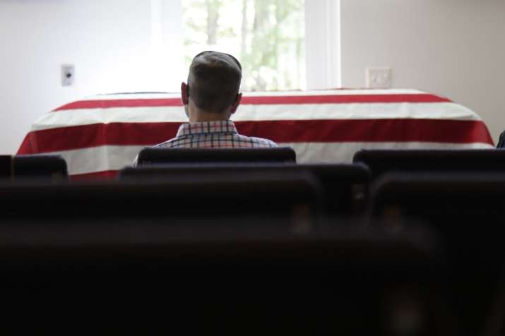 In this April 3, 2020, photo, Eric Coleman sits in front of
