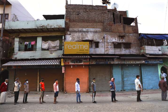 India Tv - Homeless people stand in a queue to receive food distributed by the volunteers during the nation wid