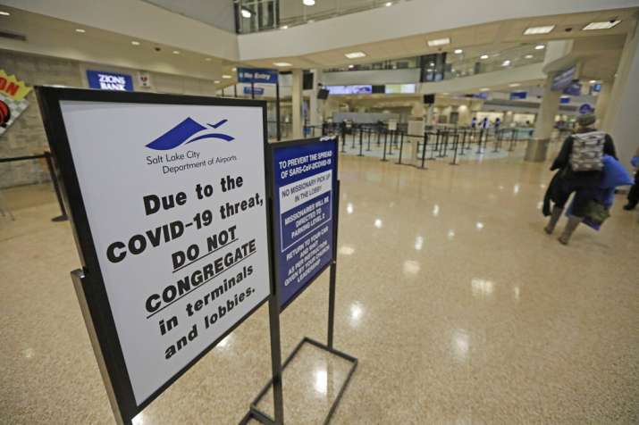 A COVID-19 sign is shown at Salt Lake City International Airport Tuesday, April 7, 2020, in Salt Lak