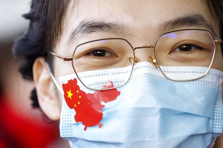 India Tv - A medical worker from China's Jilin Province wears a sticker in the shape of China on her face mask 
