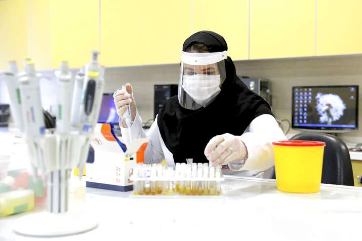 A scientist works in a lab on coronavirus testing kits just outside Tehran, Iran, Saturday, April 11