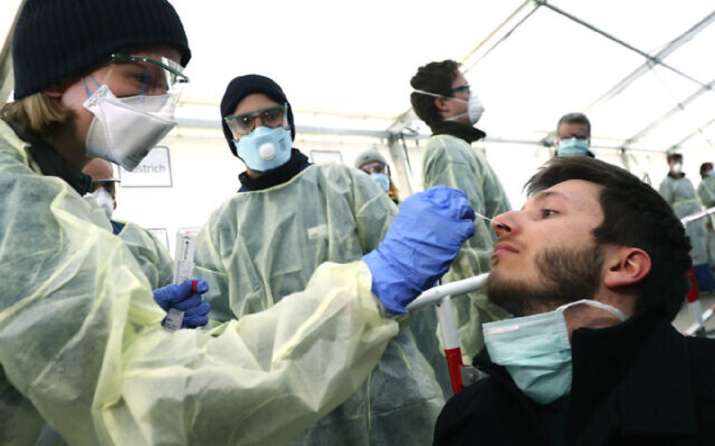 German medical employees demonstrate testing at a