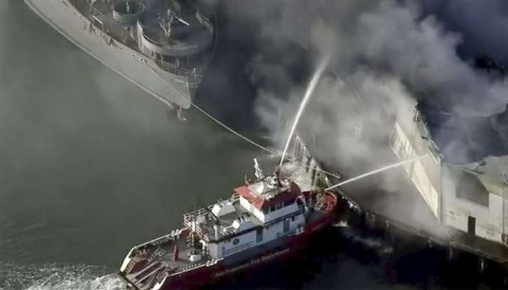 First responders battle a massive fire that erupted at a warehouse early Saturday, May 23, 2020 in S