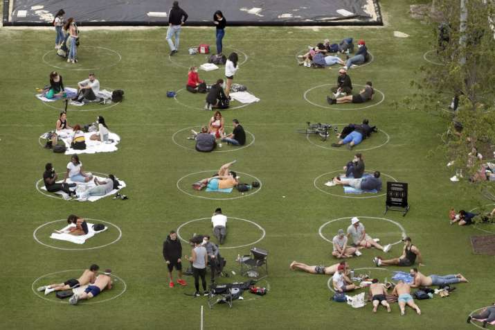 People relax in marked circles for proper social distancing at Domino Park in the Williamsburg neigh