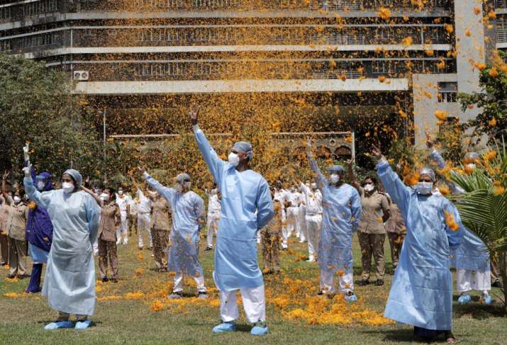 An Indian Air Force helicopter showers flower petals on the staff of INS Asvini hospital in Mumbai,