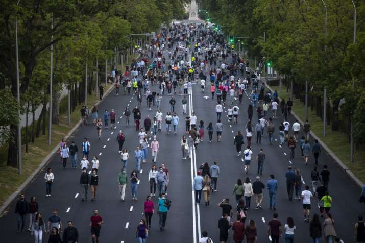 People exercise along Paseo de la Castellana after the lockdown measures imposed by the government