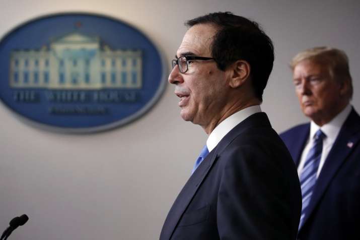In this April 21, 2020, file photo President Donald Trump listens as Treasury Secretary Steven Mnuch