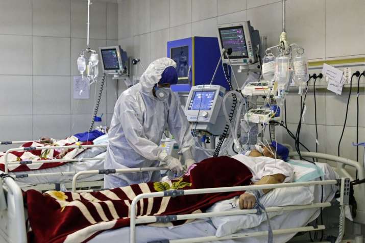 In this March 1, 2020 file photo, a medic treats a patient infected with coronavirus, at a hospital