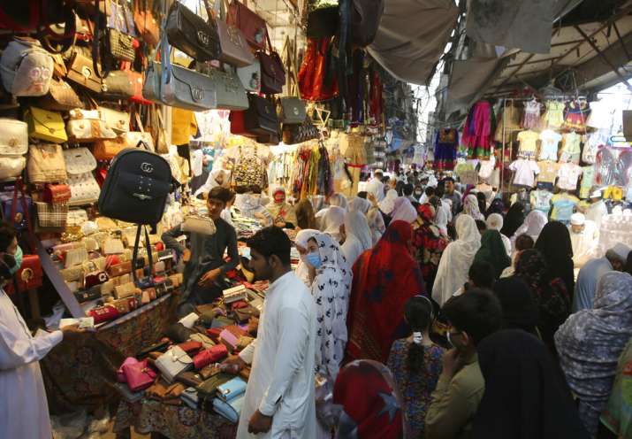 People shop in a market after the government relaxed the weeks-long lockdown that was enforced to cu
