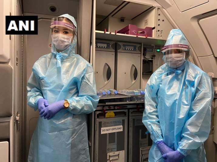 India Tv - Flight attendants dressed in PPE kits 