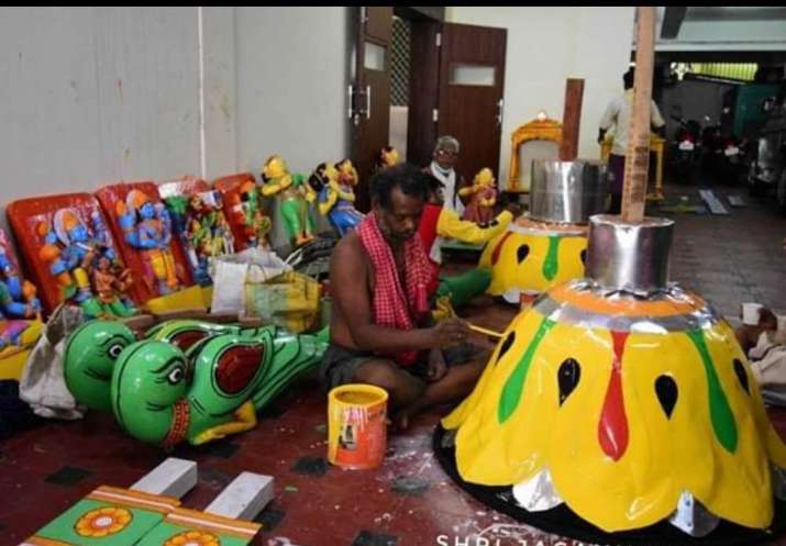 India Tv - Artists paint part of chariots ahead of Lord Jagannath Rath Yatra which has been stalled by the Supr