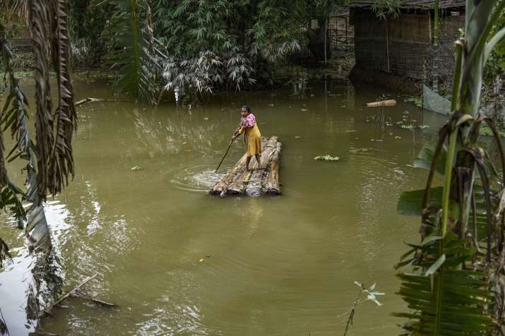 India Tv - Morigaon: A village girl rows a makeshift raft to cross a flood-affected area in Morigaon district of Assam, Monday, July 20, 2020.