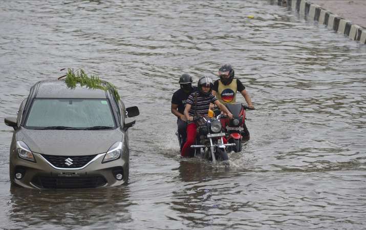 India Tv - New Delhi: Vehicles ply on a waterlogged street during heavy rain, in New Delhi, Tuesday, July 21, 2020.