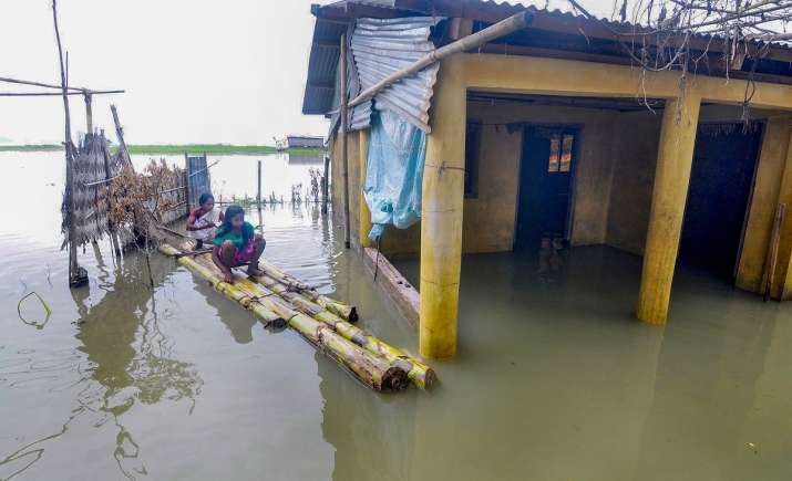 India Tv - Kamrup: Flood-affected villagers use a banana raft to move at Chandrapur in Kamrup district of Assam, Tuesday, July 21, 2020.
