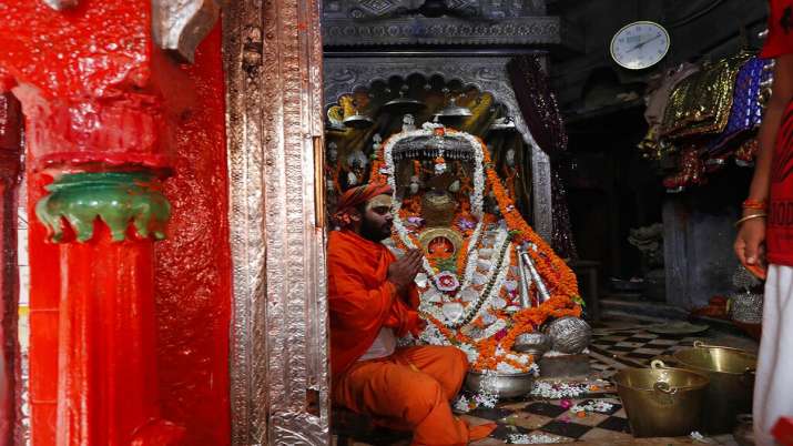 A priest perform religious rituals at Hanuman Garhi temple