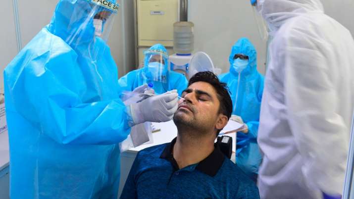 Health workers collect swab sample of a person at Indo-Israel Non-Invasive Raid Covid -19 test study