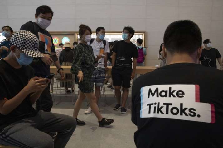 A visitor to an Apple store wears a t-shirt promoting Tik