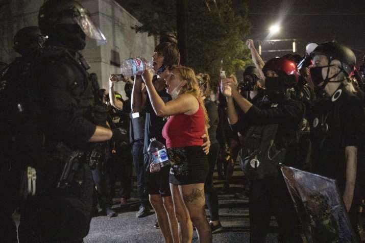 Protesters standoff with police as they take to the streets Friday, Sept. 4, 2020 in Portland, Ore. 