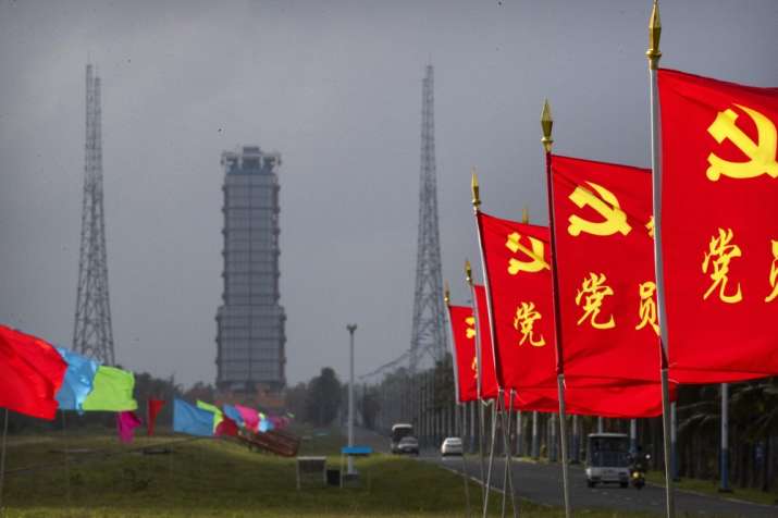 Flags with the logo of the Communist Party of China fly in